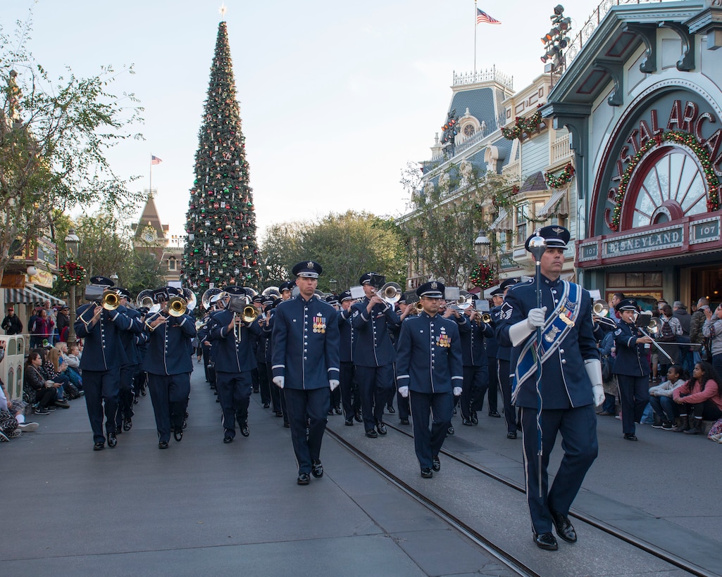 Musicians from the United States Air Force Total Force Band march down Main Street in Disneyland after performing in a Retreat Ceremony, Anaheim, Calif., Jan. 1, 2017. The USAF Total Force Band is kicking off the Air Force 70th Birthday celebration playing several venues in Southern California culminating with their appearance in the 128th Rose Parade. The band is comprised of active duty and Air National Guard musicians from around the Air Force. (U.S. Air Force photo/Louis Briscese)
