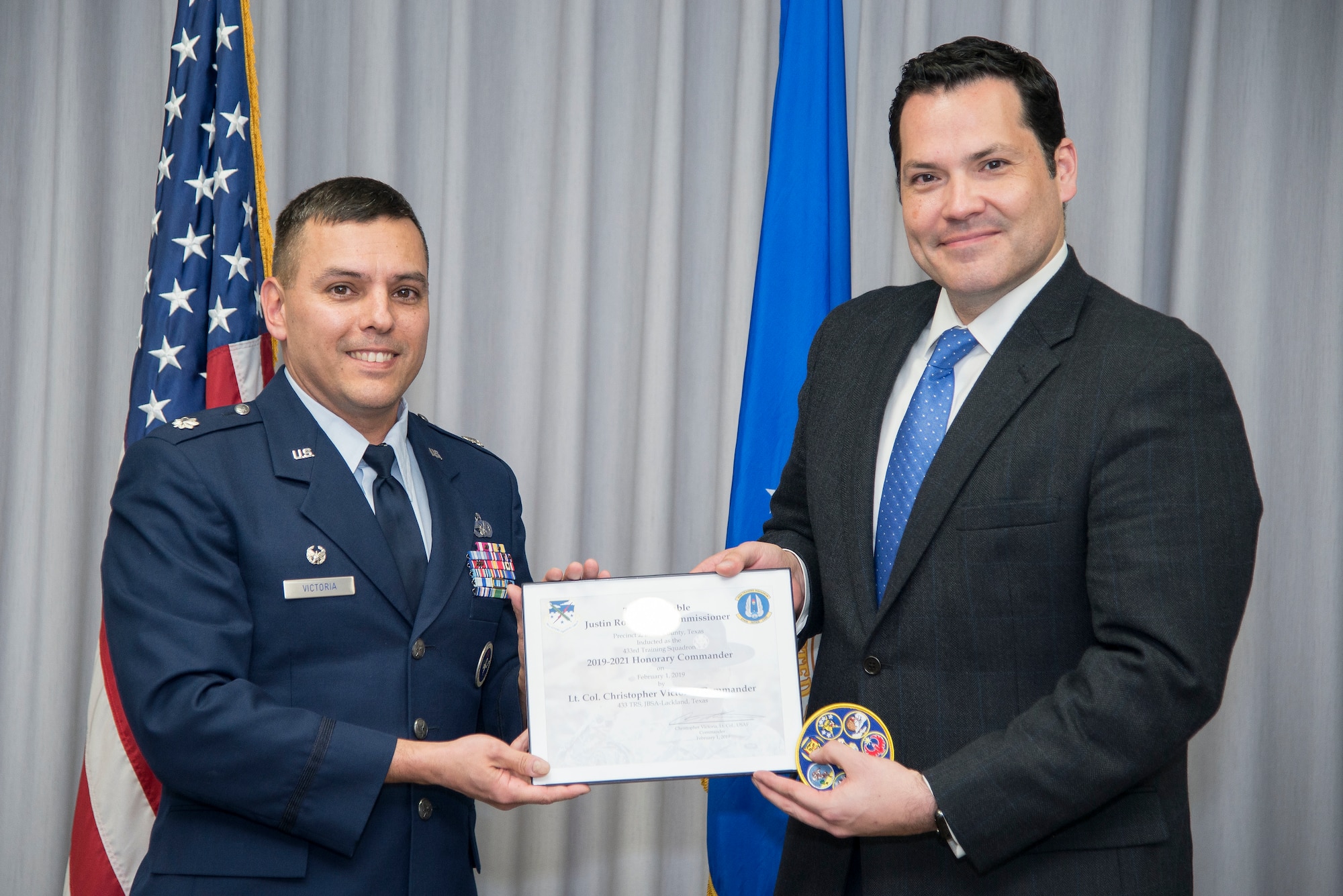 433rd Training Squadron Commander Lt. Col. Christopher Victoria presents the induction certificate to the squadron’s new honorary commander, Bexar County Precinct 2 Commissioner Justin Rodriguez, during the Feb. 1 honorary commander induction ceremony held at Joint Base San Antonio-Randolph, Texas. (U.S. Air Force photo by Sean Worrell)