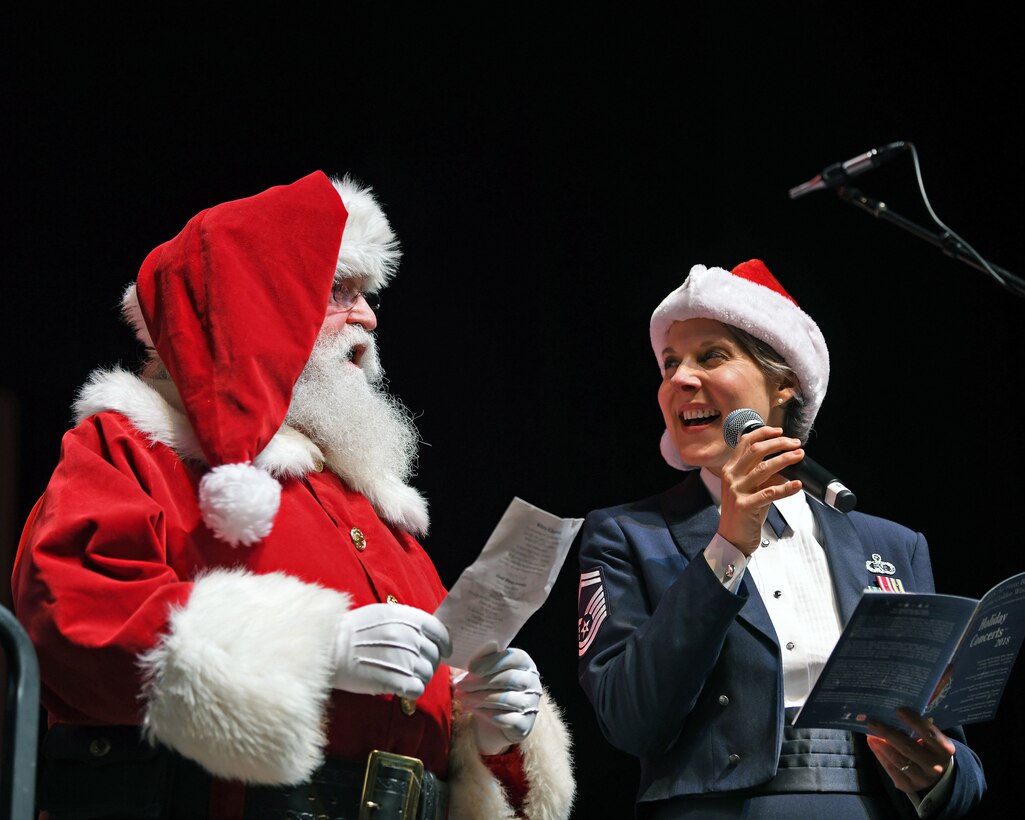 U.S. Air Force Senior Master Sgt. Paula Goetz, a vocalist with the USAF Band of the Golden West from Travis Air Force Base, California, performs with Santa Claus during a performance at the Vacaville Performing Arts Theater, Vacaville, California, Dec. 1, 2018. The performance is part of the band’s annual holiday concert series. This year they performed eight shows in seven days at six venues and performed for more than 10,000 audience members. (U.S. Air Force photo by Louis Briscese)