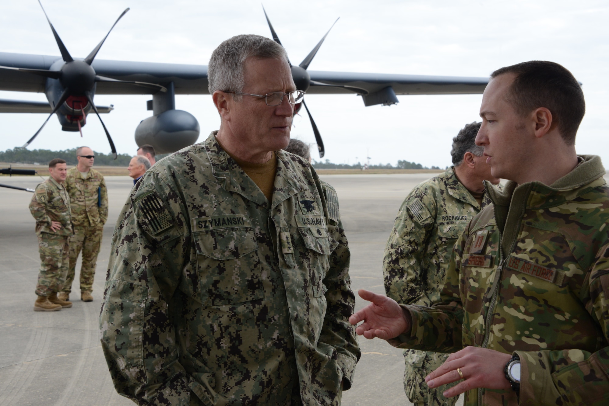 Two people talking on a flightline.