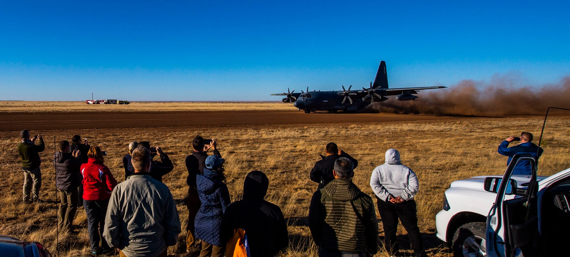 A group of people watching an aircraft land
