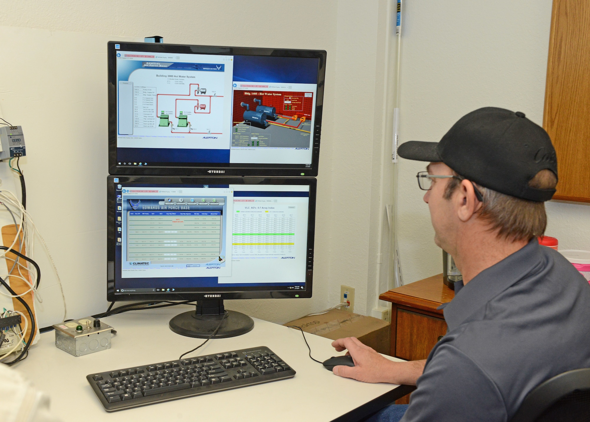 Fernando Sanchez and Minta Huddleston, 412th Civil Engineer Squadron, work in the new Industrial Control Systems Innovation Lab Feb. 7. The ICS Innovation Lab will be used primarily by field service technicians to research, develop, test and evaluate new and existing controls on Heating, Ventilation and Air Conditioning Equipment, water distribution, emergency power, sewage and more. (U.S. Air Force photo by Kenji Thuloweit)