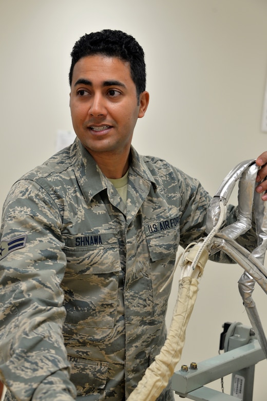 Airman trains in setting up an ejection seat.