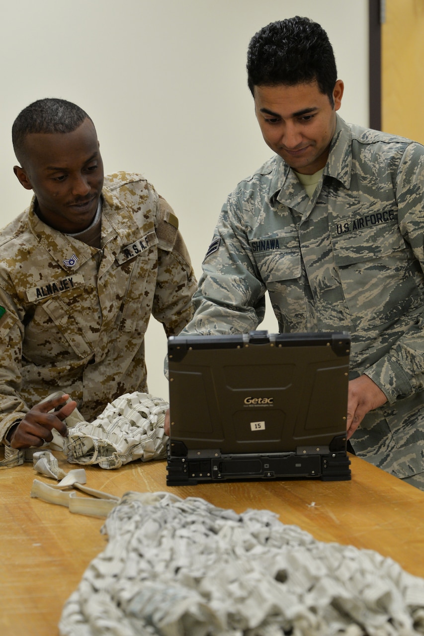 Airmen train in setting up an ejection seat system.