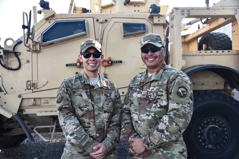 U.S. Air Force Senior Airman Anthony Castro and Master Sgt. Jonathan Herrera, assigned to the 380th Expeditionary Logistics Readiness Squadron Petroleum, Oil and Lubricants flight, pose for a photo at Al Dhafra Air Base, United Arab Emirates, Dec. 13, 2018. Castro is on his first deployment, while Herrera is potentially on his last deployment, as he’s nearing retirement. (U.S. Air Force photo by Senior Airman Mya M. Crosby)