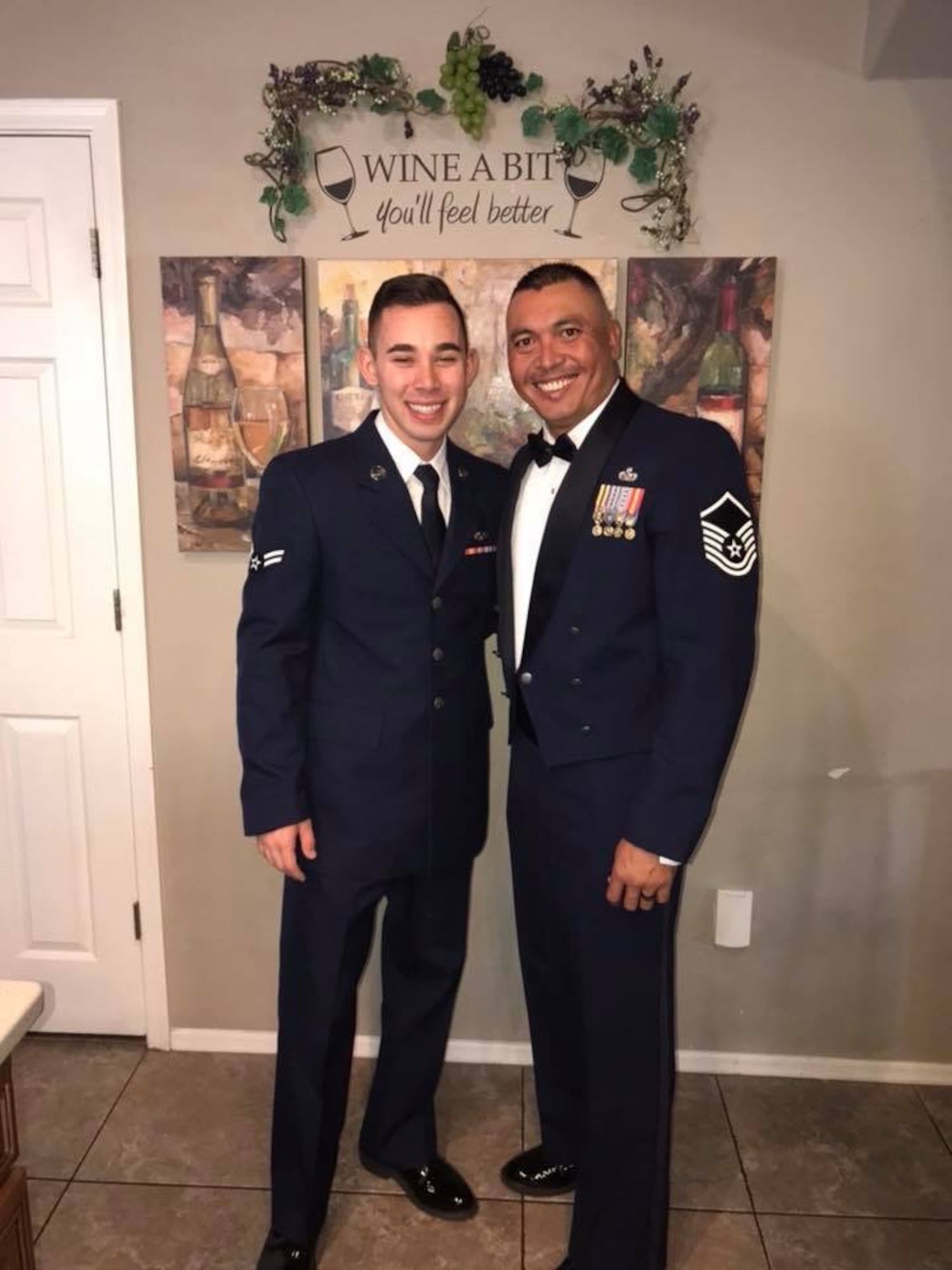 U.S. Air Force Airman 1st Class Anthony Castro and Master Sgt. Jonathan Herrera pose for a photo before Herrera’s SNCO Induction Ceremony at Davis-Monthan Air Force Base, Ariz., Aug. 31, 2018. Herrera and Castro are a father and son duo both in the Air Force, assigned to the same Air Force Specialty Code, same duty station at Davis-Monthan Air Force Base, Ariz., and now the same deployed location at Al Dhafra Air Base, United Arab Emirates. (Courtesy photo)