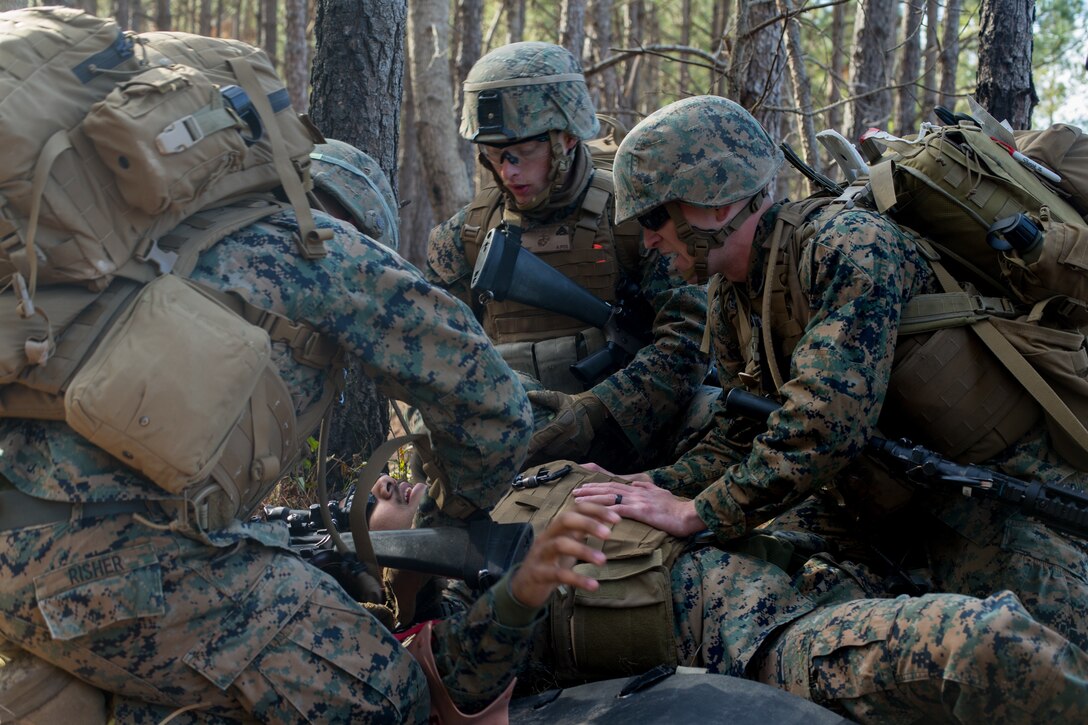 U.S. Marines with 8th Engineer Support Battalion, 2nd Marine Logistics Group, and Sailors with 2nd Medical Battalion, 2nd Marine Logistics Group, treat a simulated casualty during a casualty evacuation drill at Camp Lejeune, N.C., Jan. 30, 2019. The Marines and Sailors took part in a CASEVAC drill to train in tactical combat casualty care while integrated with Marine Heavy Helicopter Squadron 461. (U.S. Marine Corps photo by Lance Cpl. Damion Hatch Jr.)