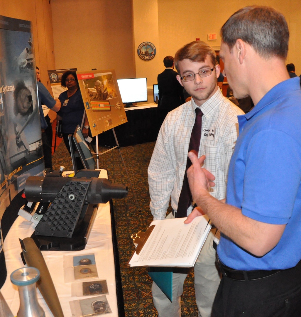 IMAGE: FREDERICKSBURG, Va. (Feb. 5, 2019) - A Naval Surface Warfare Center Dahlgren Division (NSWCDD) representative discusses career opportunities with a candidate at the NSWCDD Career Fair. The command made 36 on-the-spot job offers at the event held in the Fredericksburg Expo and Conference Center. "This is the first year that we opened the event up to non-science and engineering positions and we had an overwhelming response for our contract, financial, and information technology positions," said Shelby Khan, the NSWCDD Human Resources Recruiting Program lead. "We anticipate additional interviews and offers resulting from the career fair in the weeks to come."