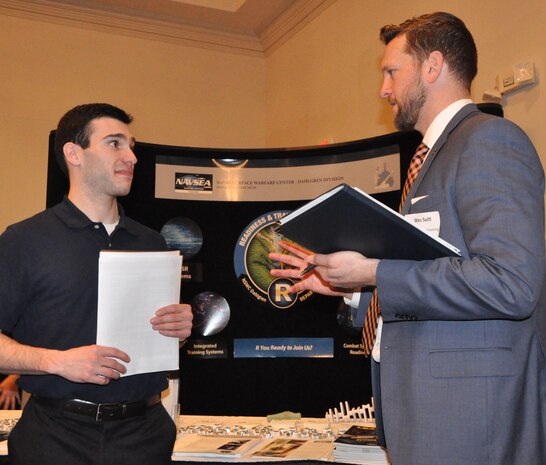 IMAGE: FREDERICKSBURG, Va. (Feb. 5, 2019) - A Naval Surface Warfare Center Dahlgren Division (NSWCDD) representative discusses career opportunities with a candidate at the NSWCDD Career Fair. The command made 36 on-the-spot job offers at the event held in the Fredericksburg Expo and Conference Center. "This is the first year that we opened the event up to non-science and engineering positions and we had an overwhelming response for our contract, financial, and information technology positions," said Shelby Khan, the NSWCDD Human Resources Recruiting Program lead. "We anticipate additional interviews and offers resulting from the career fair in the weeks to come."