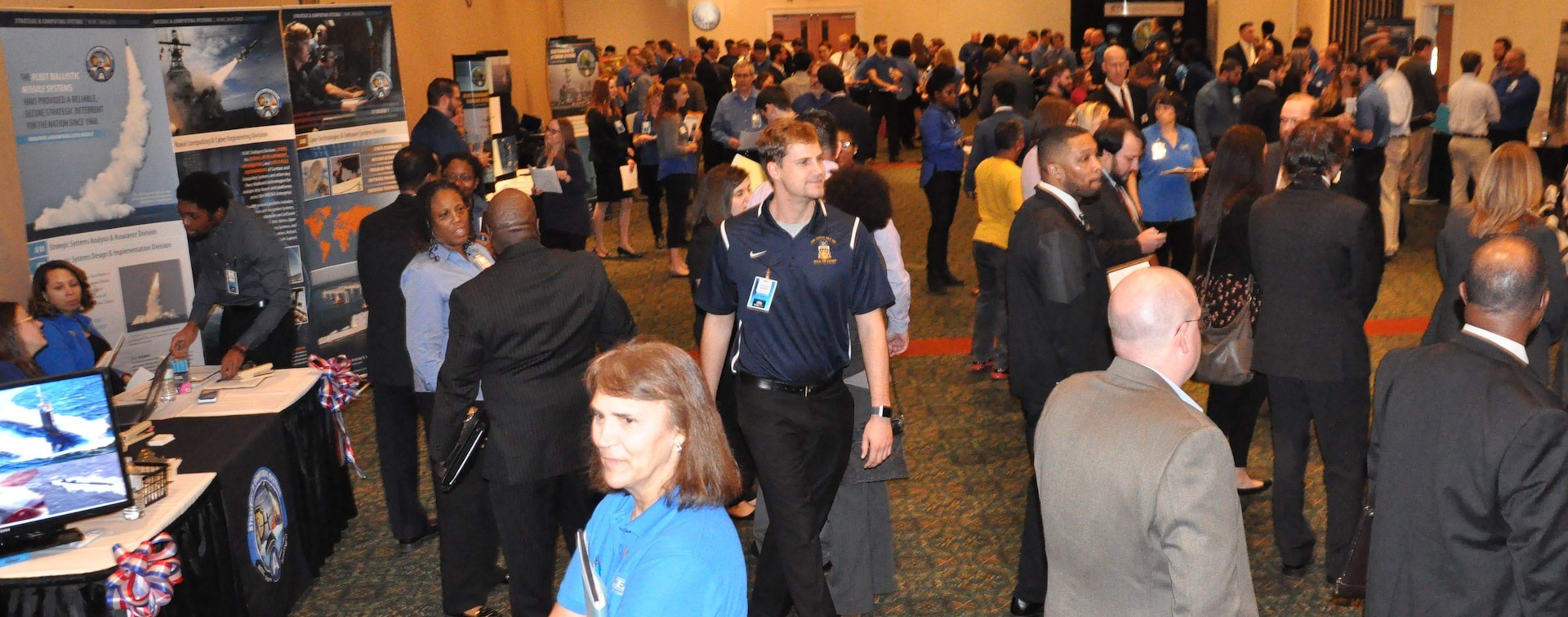 IMAGE: FREDERICKSBURG, Va. (Feb. 5, 2019) - Naval Surface Warfare Center Dahlgren Division (NSWCDD) human resource specialists and hiring managers discuss career opportunities with candidates at the NSWCDD Career Fair. The command made 36 on-the-spot job offers at the event held in the Fredericksburg Expo and Conference Center. More than 200 candidates pre-registered for the career fair where they interviewed for NSWCDD positions available for entry-level and experienced scientists, engineers, and business professionals.