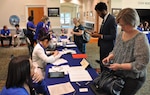 IMAGE: FREDERICKSBURG, Va. (Feb. 5, 2019) - Job candidates check in with Naval Surface Warfare Center Dahlgren Division (NSWCDD) representatives at the command's Career Fair. NSWCDD made 36 on-the-spot job offers at the event held in the Fredericksburg Expo and Conference Center. In all, 313 candidates with bachelor's, master's, and doctoral degrees in technical and business fields inquired about positions available for entry-level and experienced scientists, engineers, and business professionals.
