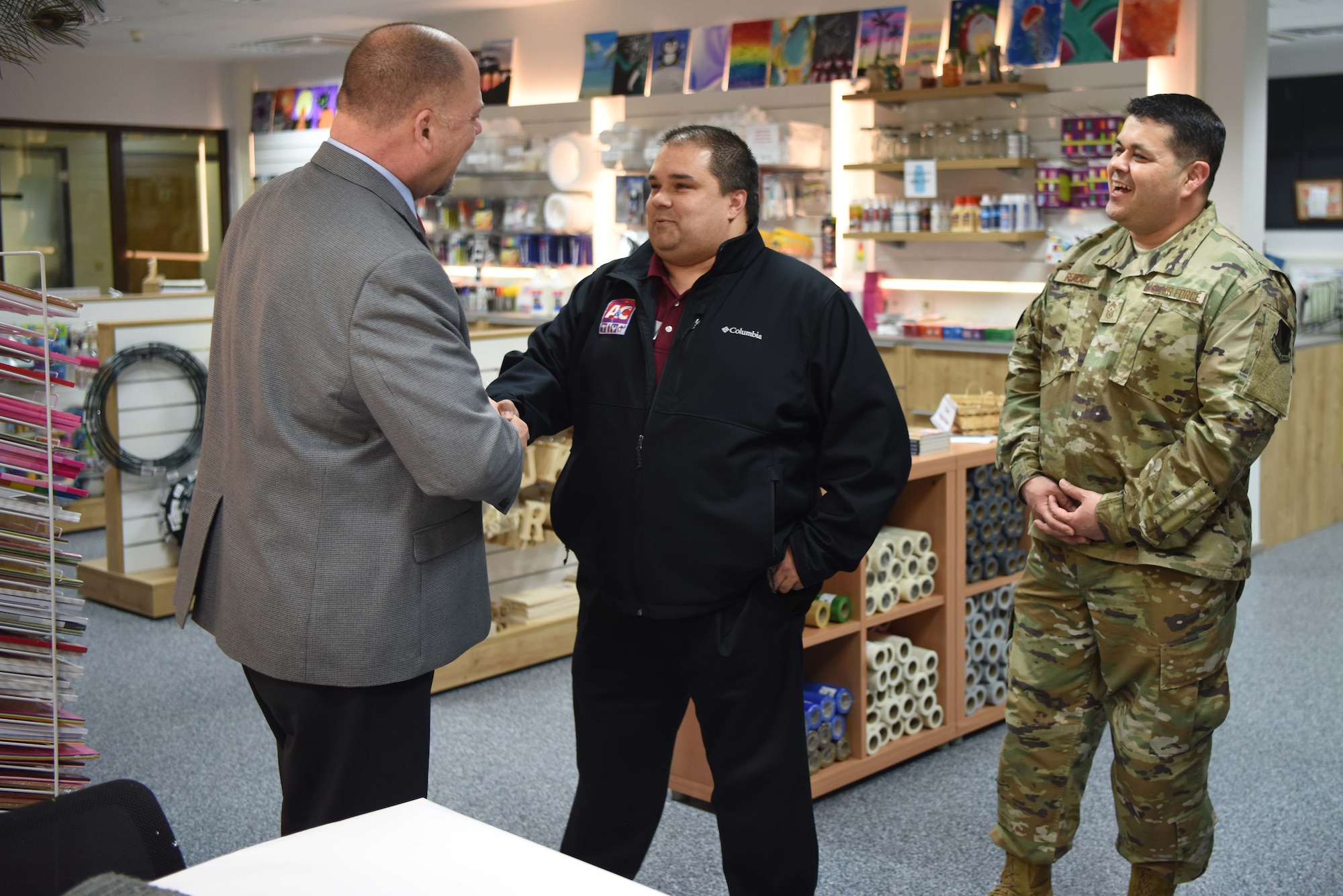 Michael “Mike” Bolado, 86th Force Support Squadron, director of Arts and Crafts Center, shakes hand with Scott C. Lockard, 86th Airlift Wing vice director, and Chief Master Sgt. Ernesto Rendon, 86th AW command chief after being selected as the Airlifter of the Week Feb. 7, 2019, on Ramstein Air Base, Germany. The Airlifter of the Week program recognizes Ramstein Airman who are devoted to making the 86th AW the World’s Best Wing.