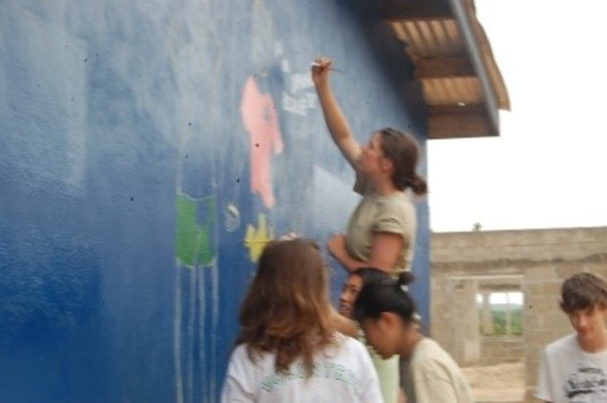 Teen volunteers painting the orphanage. (Courtesy photo/Breanna McGowan)