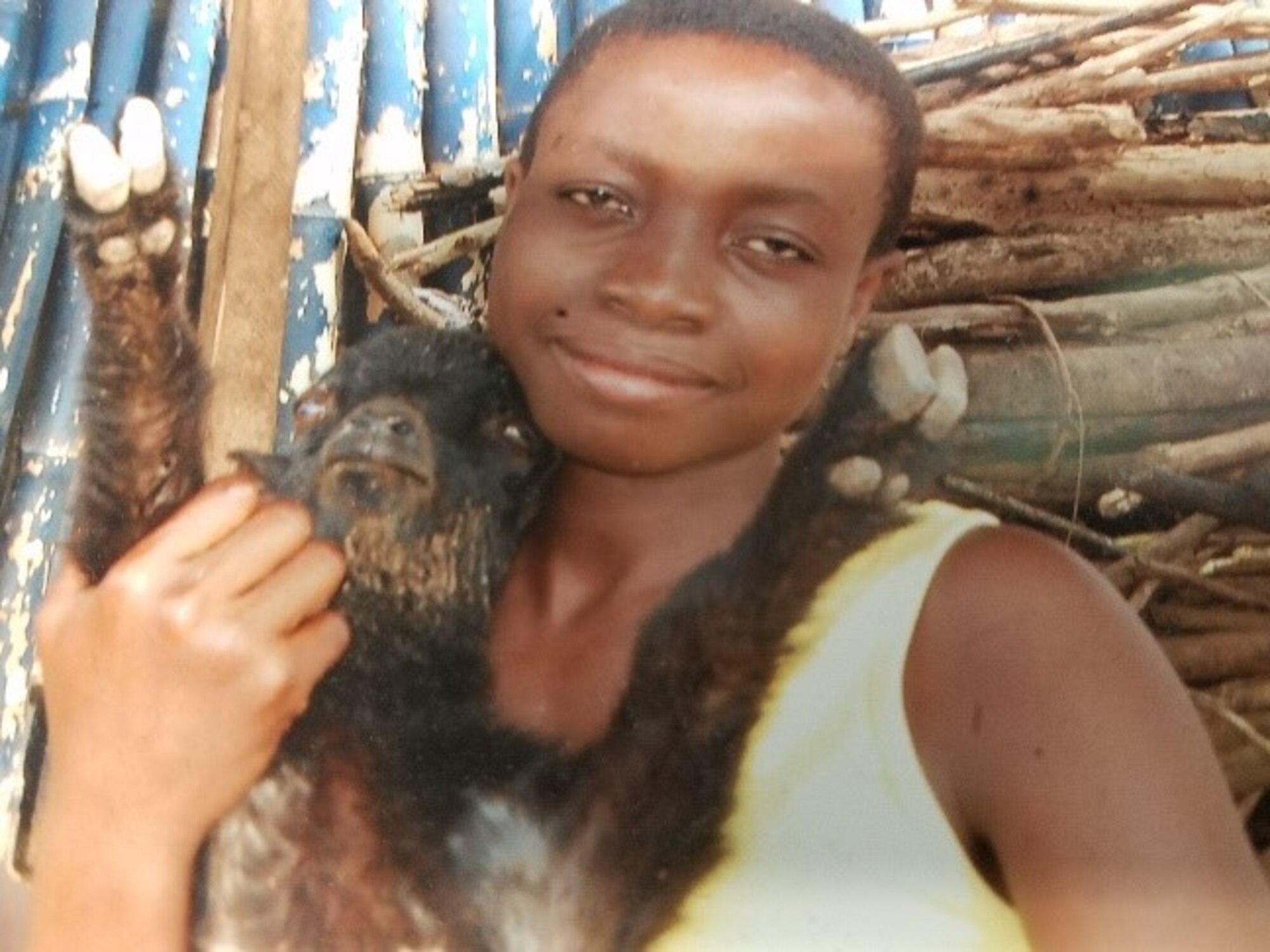 A teenage girl at an orphanage on the Cape Coast, Ghana, holding ababy goat. (Courtesy photo/Breanna McGowan)