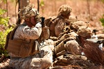 Capt. Benjamin J. O’Donnell, infantry officer with 2nd Battalion, 4th Marine Regiment, 1st Marine Division, views the targets while providing indirect fire support from M777 artillery, 81mm mortars and close air support during training Aug. 10, 2018, at Mount Bundey Training Area, Northern Territory, Australia.