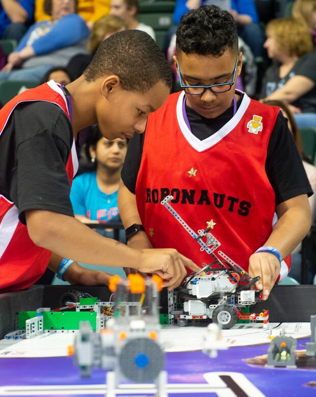 Charles Doxley (left) and Jacob Goings work with their robot during the FIRST LEGO League Ohio championship tournament Feb. 3 in Wright State University’s Ervin J. Nutter Center.