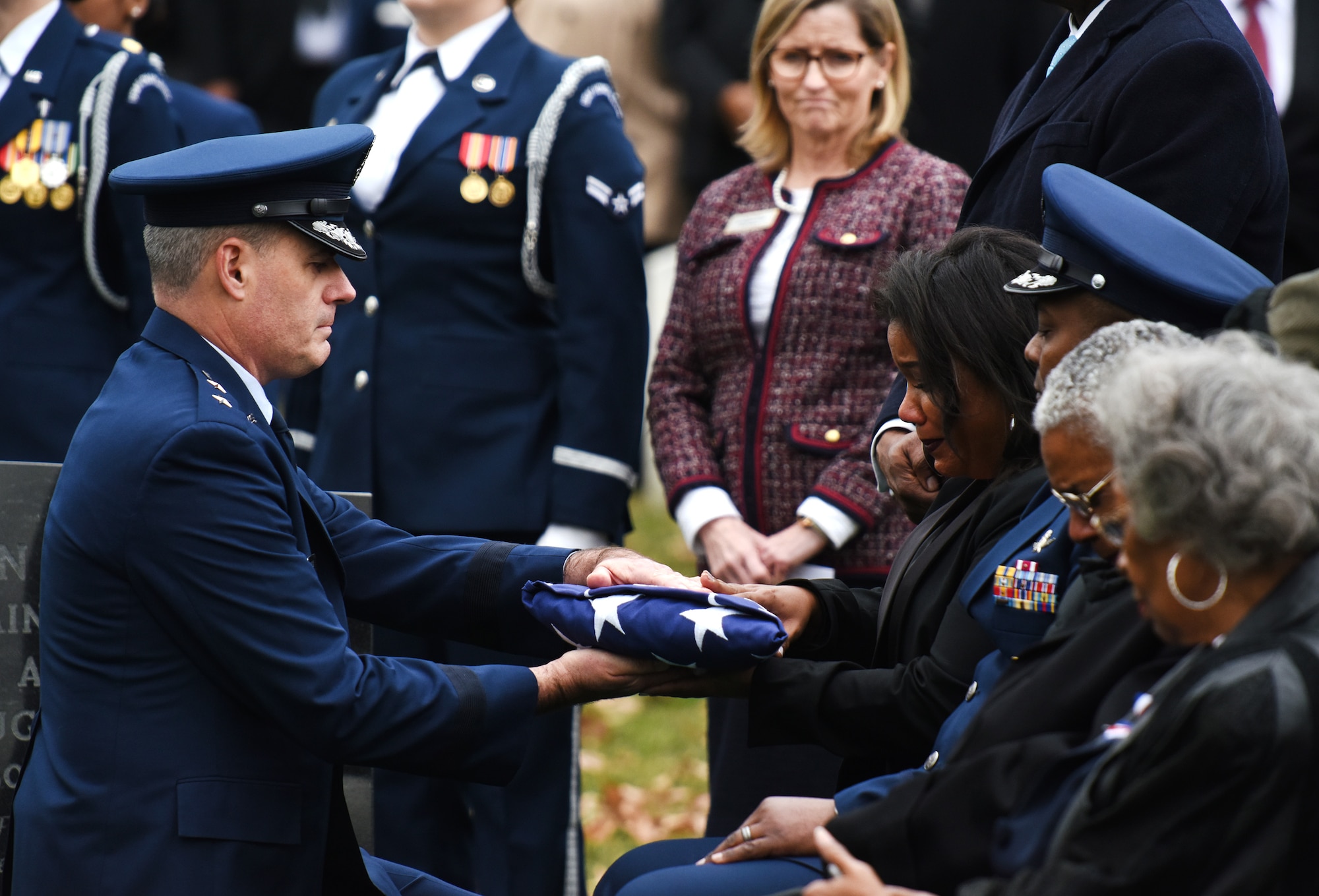 U.S. Air Force Maj. Gen. Lenny Richoux, the commander of U.S. Transportation Command’s Joint Enabling Capabilities Command, presents the American Flag to retired U.S. Air Force Maj. Gen. Mareclite Harris’s daughter, Tenecia Harris, during a full honors funeral at Arlington National Cemetery, Arlington, Va., Feb. 7, 2019. Gen. Harris’s accomplishments include being the first woman aircraft maintenance officer, one of the first two women air officers commanding at the U.S. Air Force Academy and the first woman deputy commander for maintenance. She also served as a White House social aide during the Carter administration. (U.S. Air Force photo by Staff Sgt. Rusty Frank)