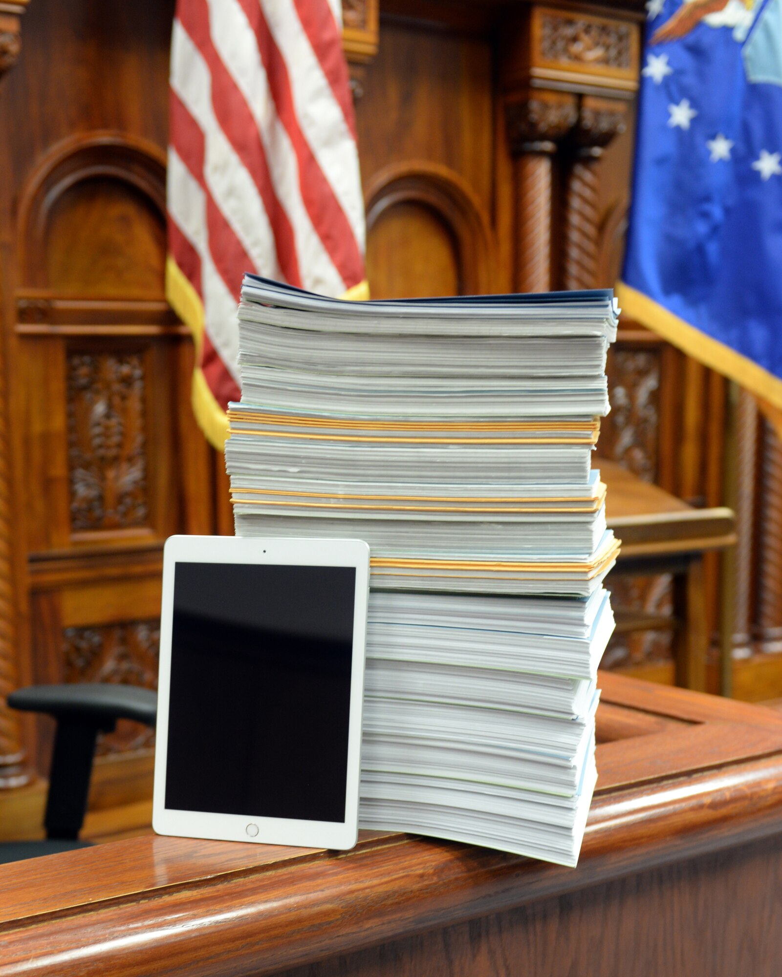 A tablet leans on a stack of legal documents Feb. 8, 2019, on Offutt Air Force Base, Neb. The 55th Wing Judge Advocate office recently purchased to tablets in order to reduce time, man-hours and paper waste. (U.S. Air Force photo by Kendra Williams)