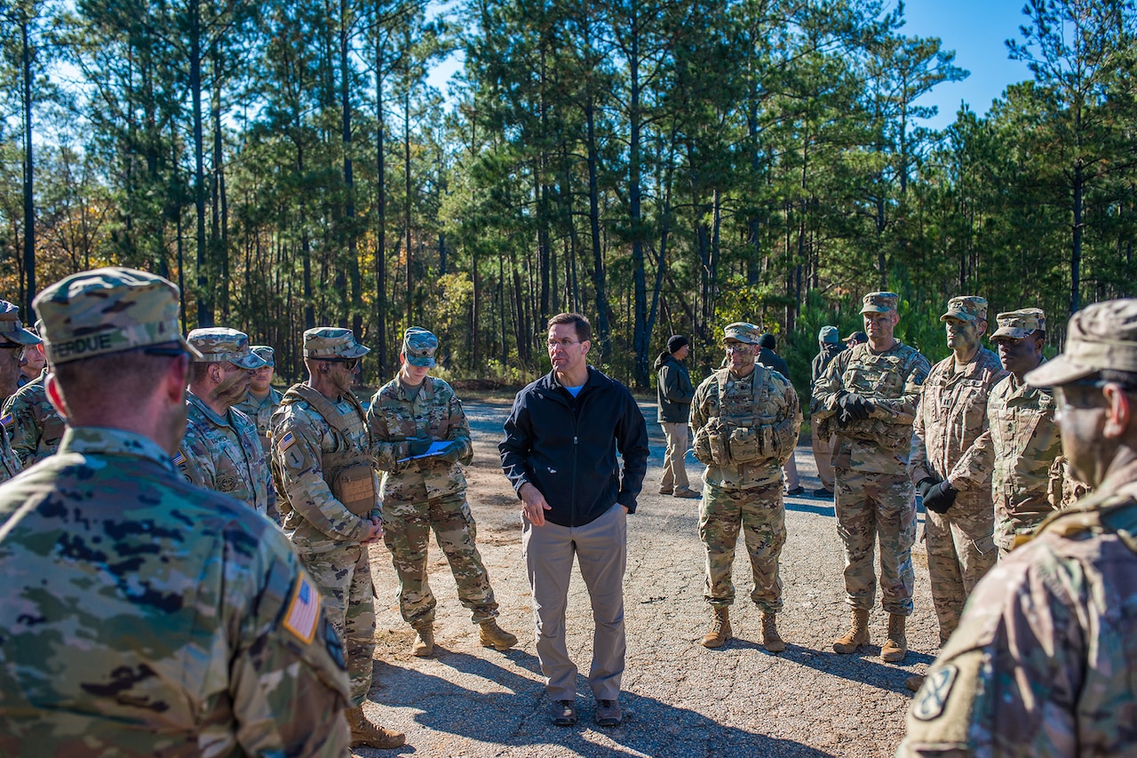 A man speaks to a group of soldiers.