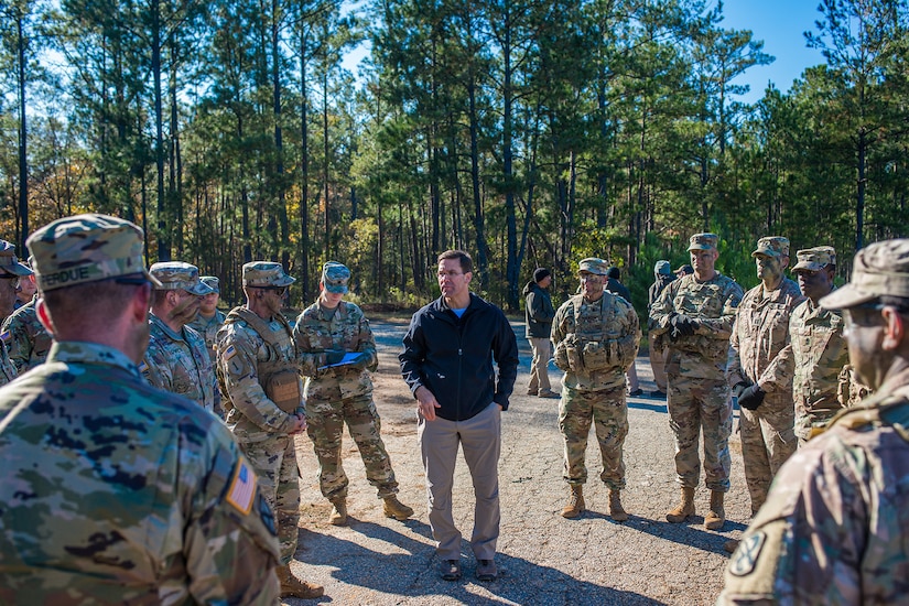 A man speaks to a group of soldiers.