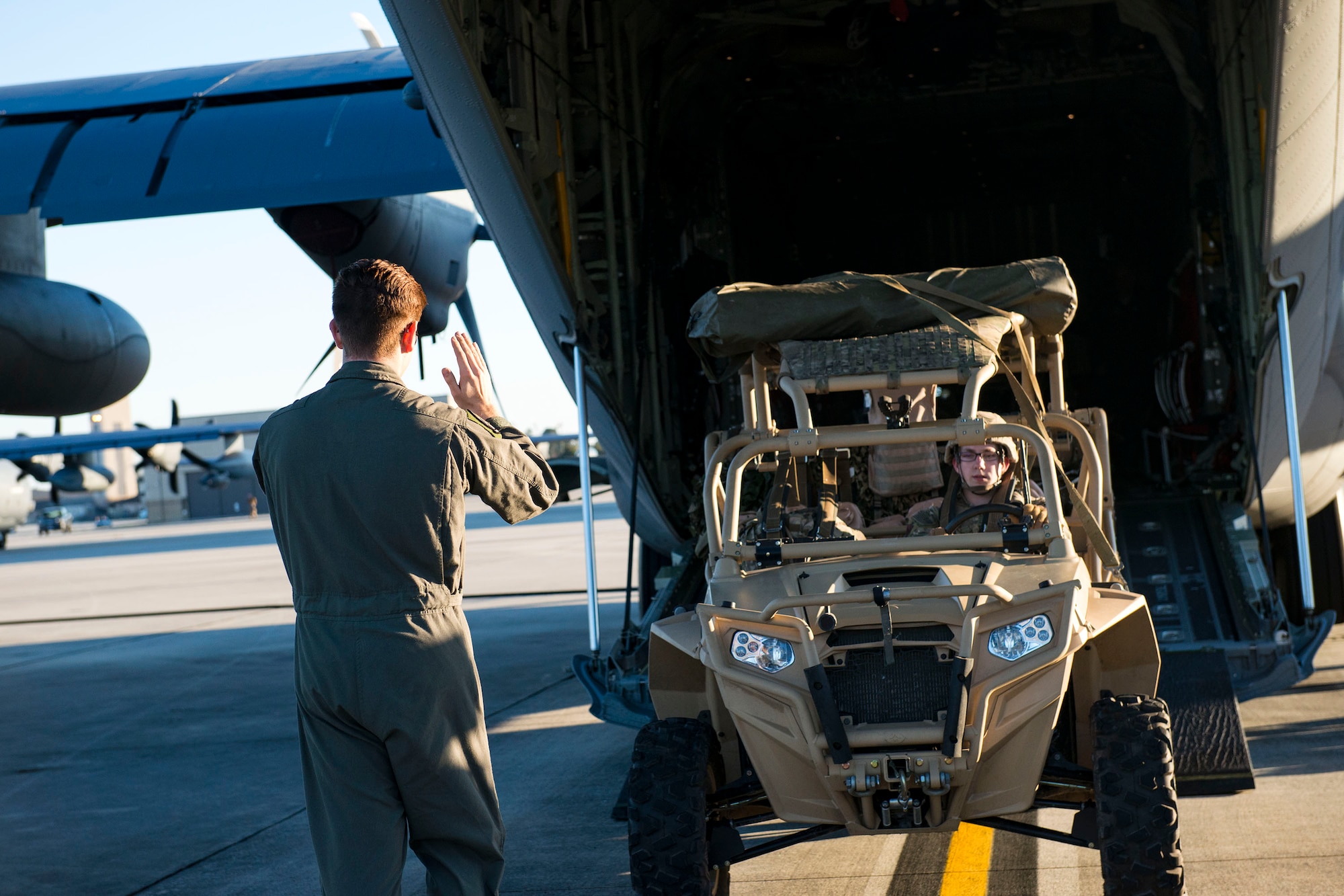 Senior Airman Sam Neas, 71st Rescue Squadron loadmaster, marshals a military RZR all-terrain vehicle during airfield security training, Jan. 28, 2019, at Moody Air Force Base, Ga. The training was geared toward bolstering the 823d Base Defense Squadron’s adaptive base readiness, which consisted of improving Airmen’s capabilities to effectively and efficiently on-load equipment along with more than 30 fully-equipped personnel into an aircraft, followed by establishing airfield security. (U.S. Air Force photo by Airman 1st Class Erick Requadt)