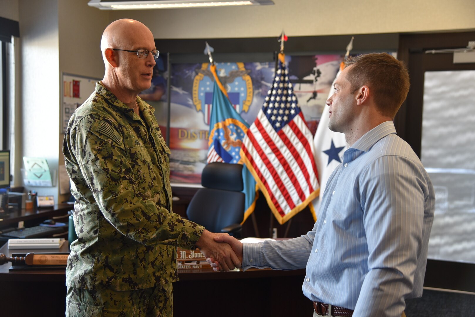 Distribution acquisition specialist honored with commander coin