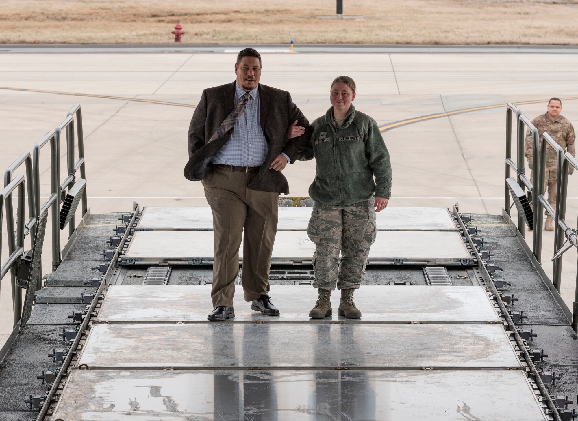 U.S. Air Force Airman 1st Class Michelle Speer, a 436th Aerial Port Squadron air transportation journeyman, walks down the aisle of a 60K aircraft cargo loader, escorted by her father, during her wedding ceremony Jan. 29, 2018, at Dover Air Force Base, Delaware. (U.S. Air Force photo by Roland Balik)