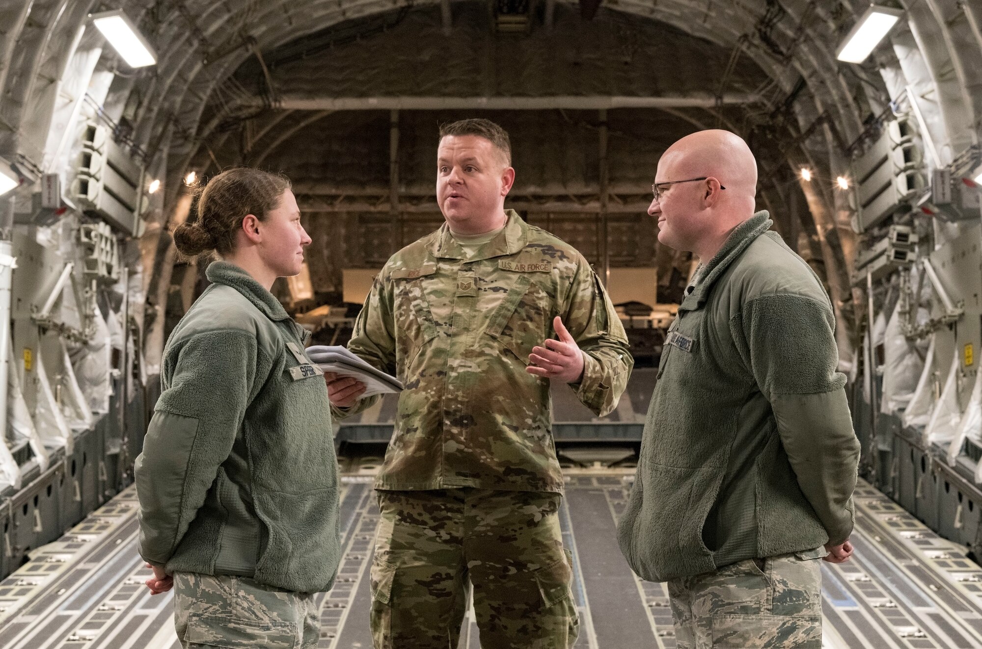 U.S. Air Force Tech. Sgt. Joseph Rice, 436th Aerial Port Squadron ramp operations supervisor, officiates a wedding ceremony for U.S. Airmen in the cargo compartment of a C-17 Globemaster III Jan. 29, 2018, at Dover Air Force Base, Delaware. Rice has been ordained for 10 years, but this was the first wedding he had ever officiated aboard an aircraft. (U.S. Air Force photo by Roland Balik)