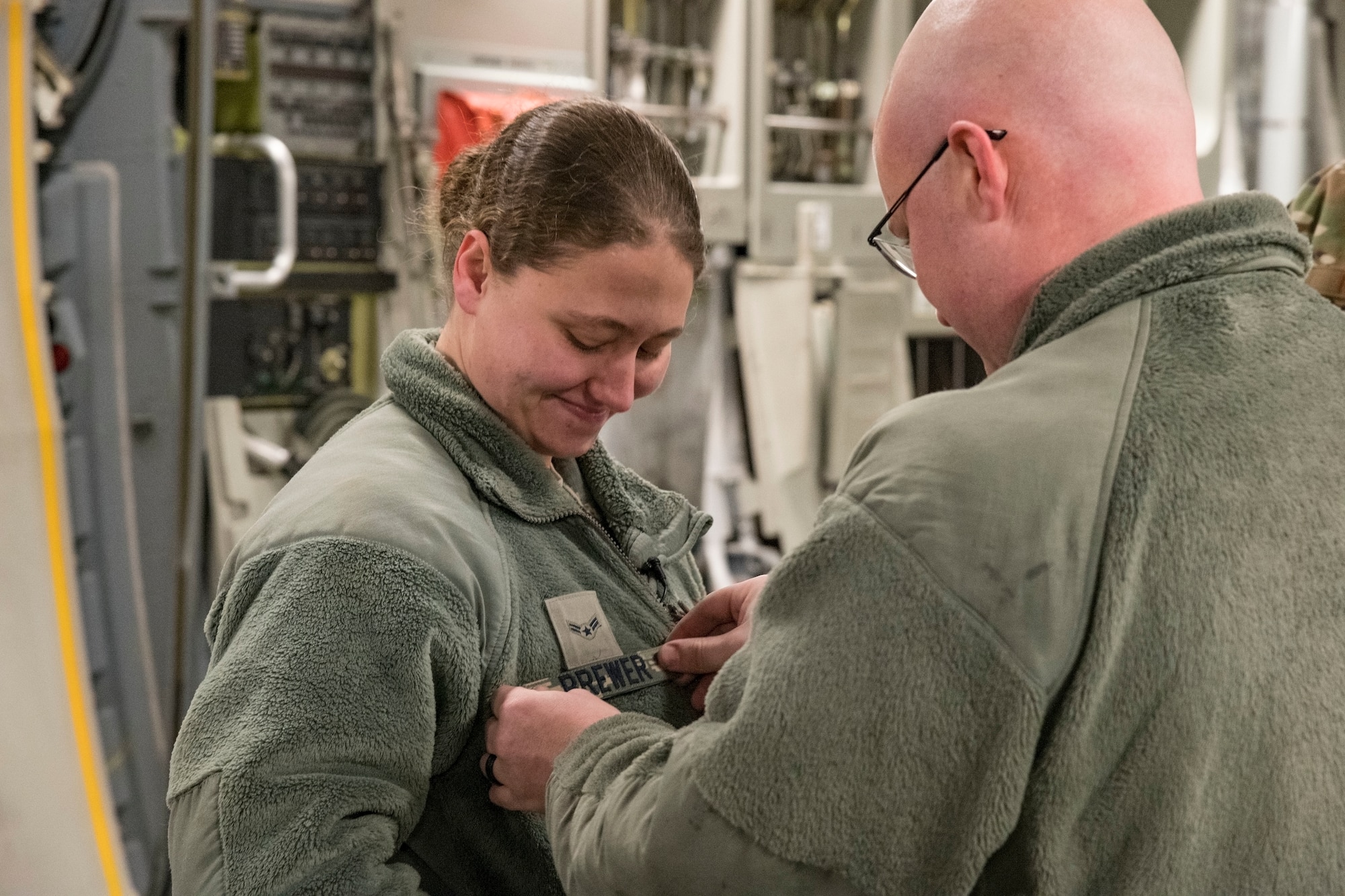 U.S. Air Force Airman 1st Class Joshua Brewer, 736th Aircraft Maintenance Squadron electrical and environmental systems journeyman, replaces his wife’s nametape with one bearing his last name during a wedding ceremony Jan. 29, 2018, at Dover Air Force Base, Delaware. Brewer wed U.S. Air Force Airman 1st Class Michelle Speer, 436th Aerial Port Squadron air transportation journeyman, in front of family and over 20 Wingmen in the cargo compartment of a C-17 Globemaster III. (U.S. Air Force photo by Roland Balik)