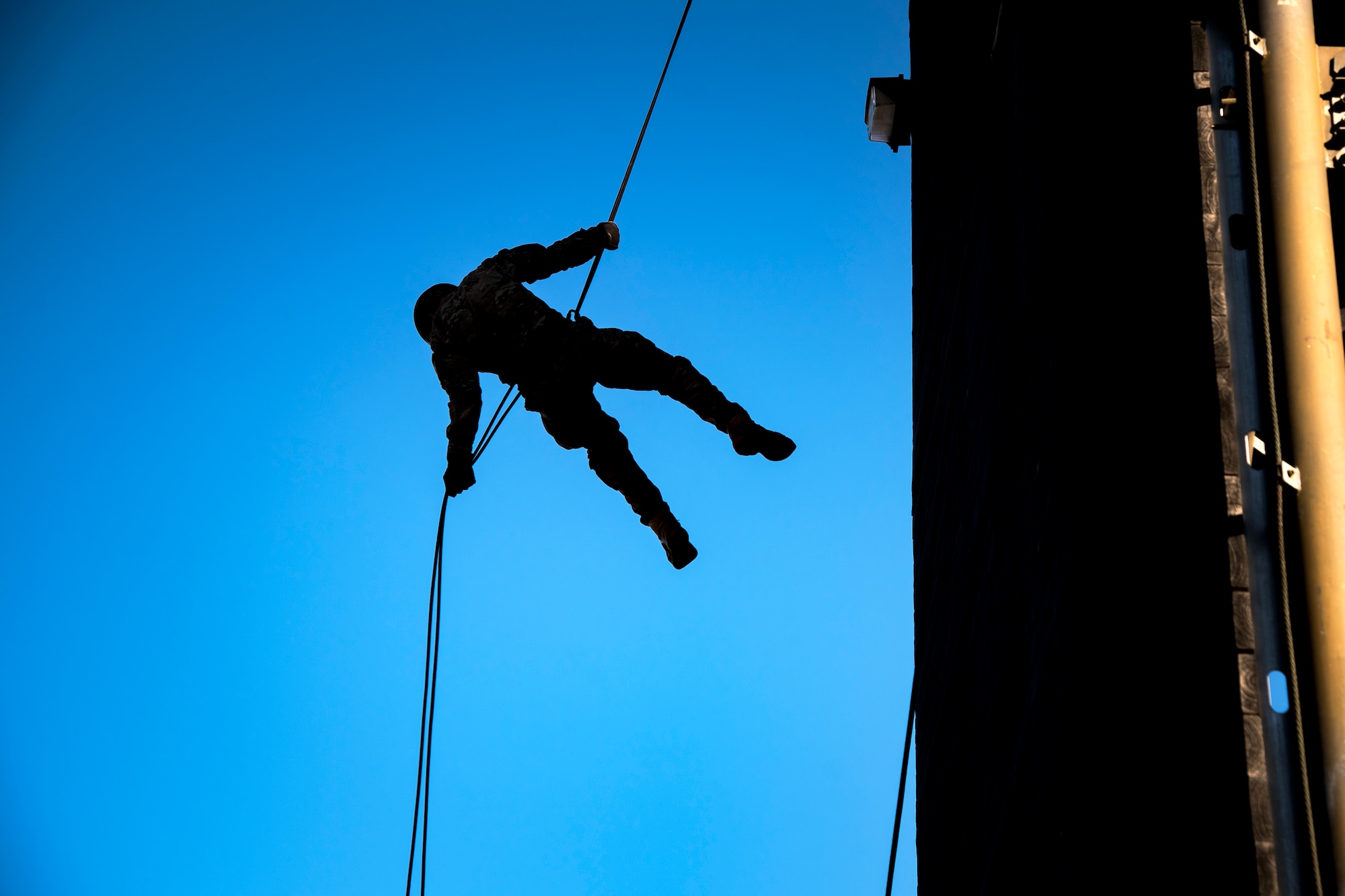 An Airman rappels down the Safeside Rappel Tower during an Army Air Assault Assessment (AAA), Jan. 28, 2019, at Moody Air Force Base, Ga. Airmen demonstrated their comprehensive rappel tower knowledge to help determine their overall readiness for Army Air Assault school (U.S. Air Force photo by Airman First Class Eugene Oliver)