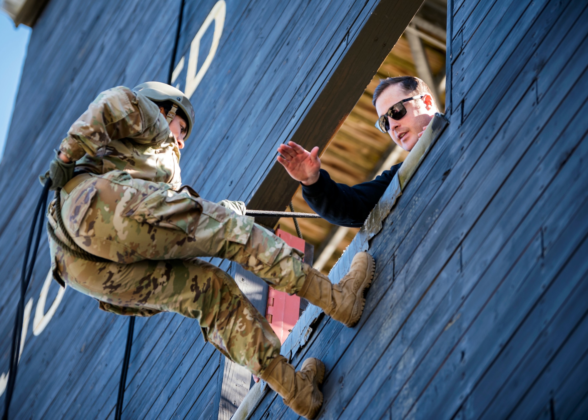 Staff Sgt. Joshua Basinger, right, 822d Base Defense Squadron (BDS) fire team leader and cadre team member, gives rappel instructions to Staff Sgt. Stephanie Dravus, 822 BDS fire team member, during an Army Air Assault Assessment, Jan. 28, 2019, at Moody Air Force Base, Ga. Airmen demonstrated their comprehensive rappel tower knowledge to help determine their overall readiness for Army Air Assault school (U.S. Air Force photo by Airman First Class Eugene Oliver)