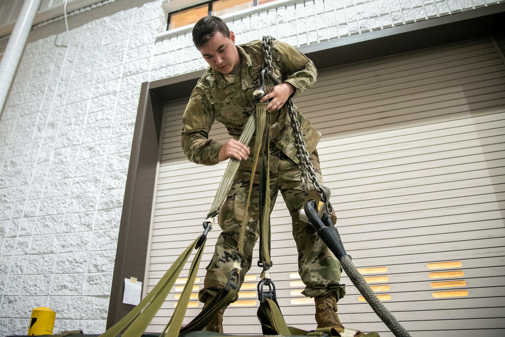Senior Airman Jarod Barr, 23d Security Forces Squadron installation patrolman, inspects the sling load components of an 822 cargo bag during an Army Air Assault Assessment (AAA), Jan. 29, 2019, at Moody Air Force Base, Ga. Airmen were required to identify structural deficiencies on the sling load portion of the cargo bag as part of an overall assessment to determine their readiness to attend Army Air Assault School. (U.S. Air Force photo by Airman First Class Eugene Oliver)