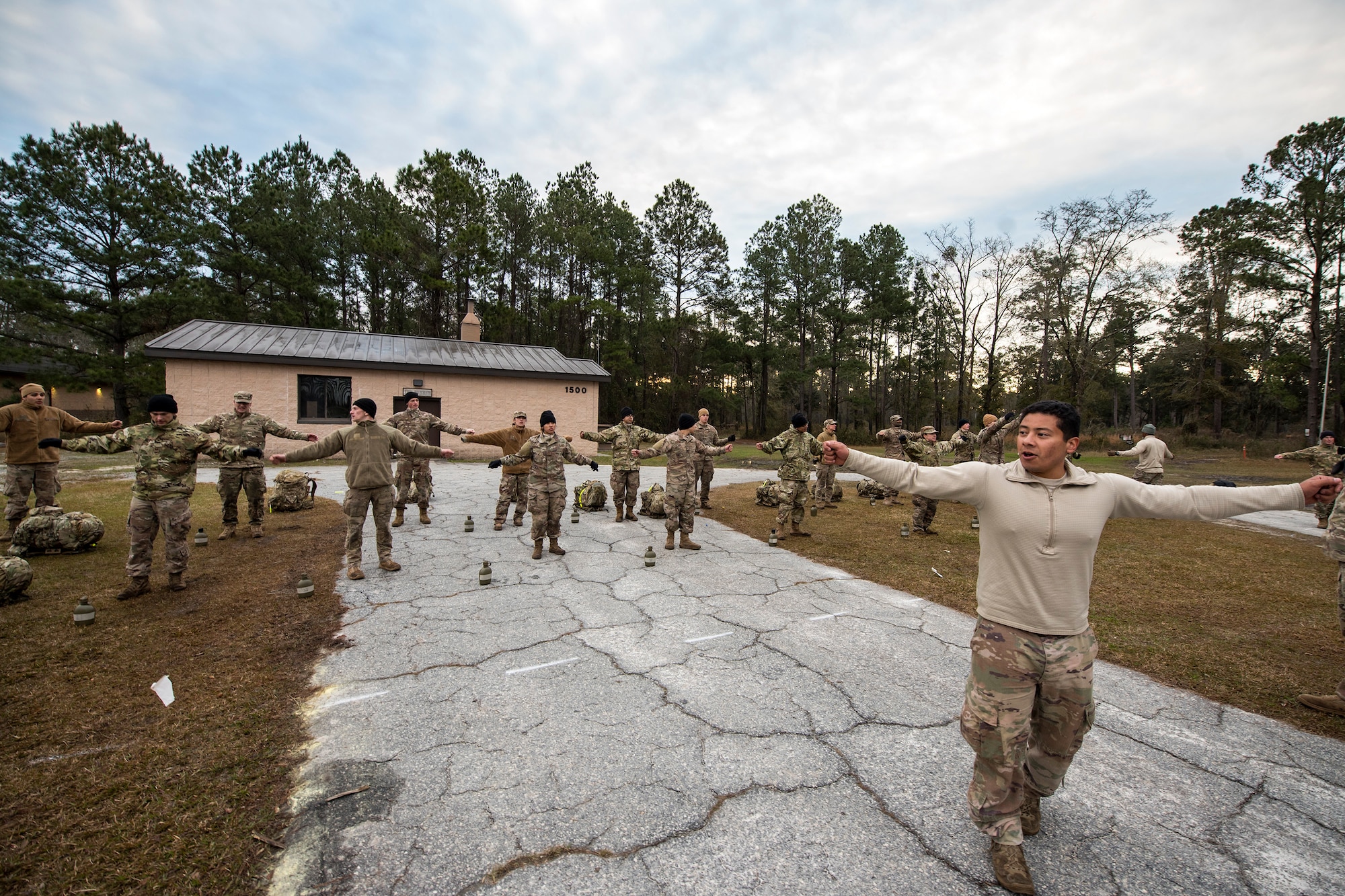 Staff Sgt. Ulysses Ortiz, right, 820th Combat Operations Squadron unit trainer and lead cadre team member, leads Airmen through calisthenics during an Army Air Assault Assessment (AAA), Jan. 31, 2019, at Moody Air Force Base, Ga. The AAA is designed to determine Airmen’s physical and mental readiness before being able to attend Army Air Assault school. (U.S. Air Force photo by Airman First Class Eugene Oliver)