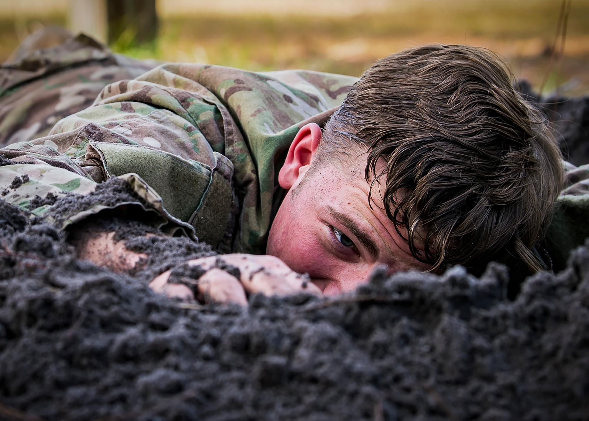 An Airman from the 820th Base Defense Group low crawls through an obstacle during an Army Air Assault Assessment (AAA), Jan. 30, 2019, at Camp Blanding, Fla. The AAA is designed to determine Airmen’s physical and mental readiness before being selected to attend Army Air Assault school. (U.S. Air Force photo by Airman First Class Eugene Oliver)