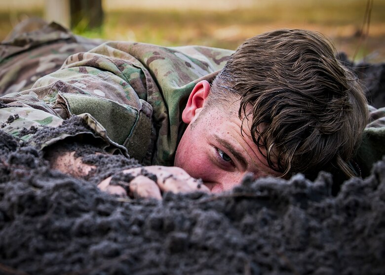 An Airman from the 820th Base Defense Group low crawls through an obstacle during an Army Air Assault Assessment (AAA), Jan. 30, 2019, at Camp Blanding, Fla. The AAA is designed to determine Airmen’s physical and mental readiness before being selected to attend Army Air Assault school. (U.S. Air Force photo by Airman First Class Eugene Oliver)