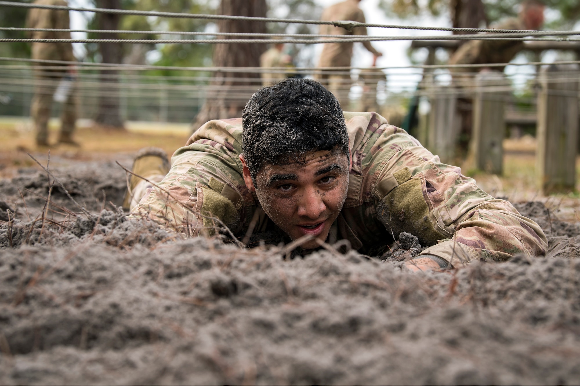 Airman First Class Jaime Serna, 822d Base Defense Squadron fireteam member, low crawls through an obstacle during an Army Air Assault Assessment (AAA), Jan. 30, 2019, at Camp Blanding, Fla. The AAA is designed to determine Airmen’s physical and mental readiness before being selected to attend Army Air Assault school. (U.S. Air Force photo by Airman First Class Eugene Oliver)