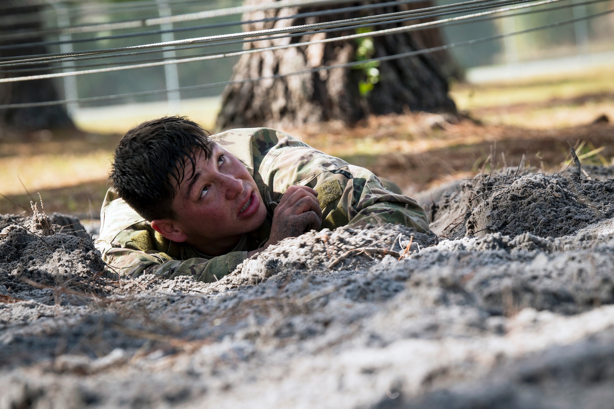 Senior Airman Shawn King, 823d Base Defense Squadron fireteam member, low crawls through an obstacle during an Army Air Assault Assessment (AAA), Jan. 20, 2019, at Camp Blanding, Fla. The AAA is designed to determine Airmen’s physical and mental readiness before being selected to attend Army Air Assault school. (U.S. Air Force photo by Airman First Class Eugene Oliver)
