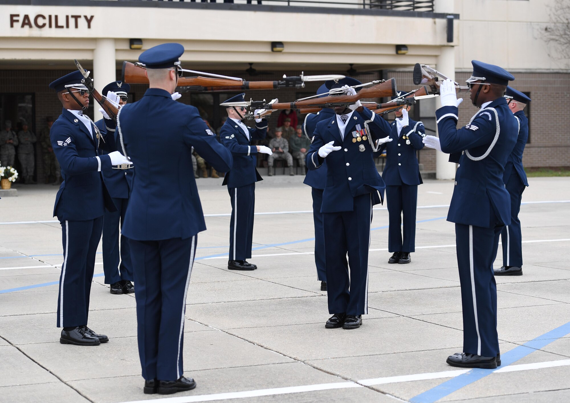 The U.S. Air Force Honor Guard Drill Team debuts their 2019 routine in front of Keesler leadership and 81st Training Group Airmen on the Levitow Training Support Facility drill pad at Keesler Air Force Base, Mississippi, Feb. 8, 2019. The team comes to Keesler every year for five weeks to develop a new routine that they will use throughout the year. (U.S. Air Force photo by Kemberly Groue)