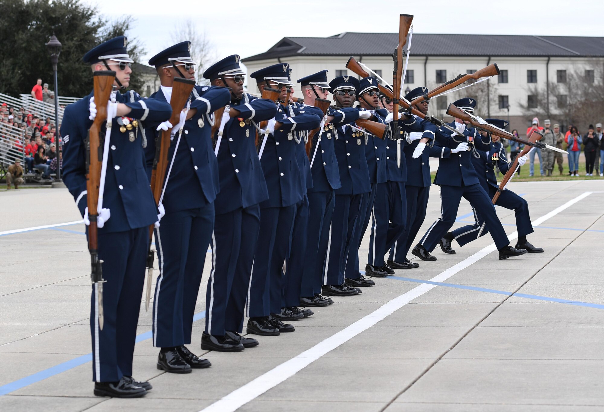 The U.S. Air Force Honor Guard Drill Team debuts their 2019 routine in front of Keesler leadership and 81st Training Group Airmen on the Levitow Training Support Facility drill pad at Keesler Air Force Base, Mississippi, Feb. 8, 2019. They are the nation's most elite honor guard, serving the President of the United States, the Air Force's most senior leaders and performing nationwide for the American public. The team comes to Keesler every year for five weeks to develop a new routine that they will use throughout the year. (U.S. Air Force photo by Kemberly Groue)