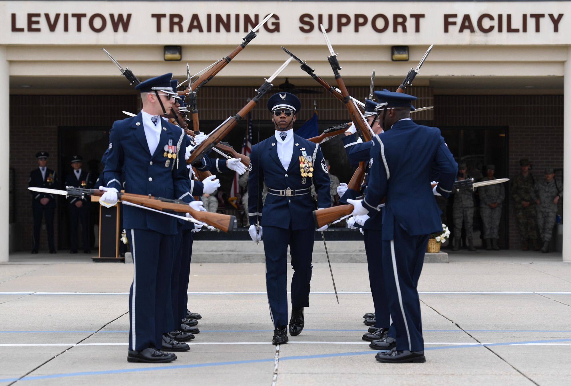 The U.S. Air Force Honor Guard Drill Team debuts their 2019 routine in front of Keesler leadership and 81st Training Group Airmen on the Levitow Training Support Facility drill pad at Keesler Air Force Base, Mississippi, Feb. 8, 2019. The team comes to Keesler every year for five weeks to develop a new routine that they will use throughout the year. (U.S. Air Force photo by Kemberly Groue)