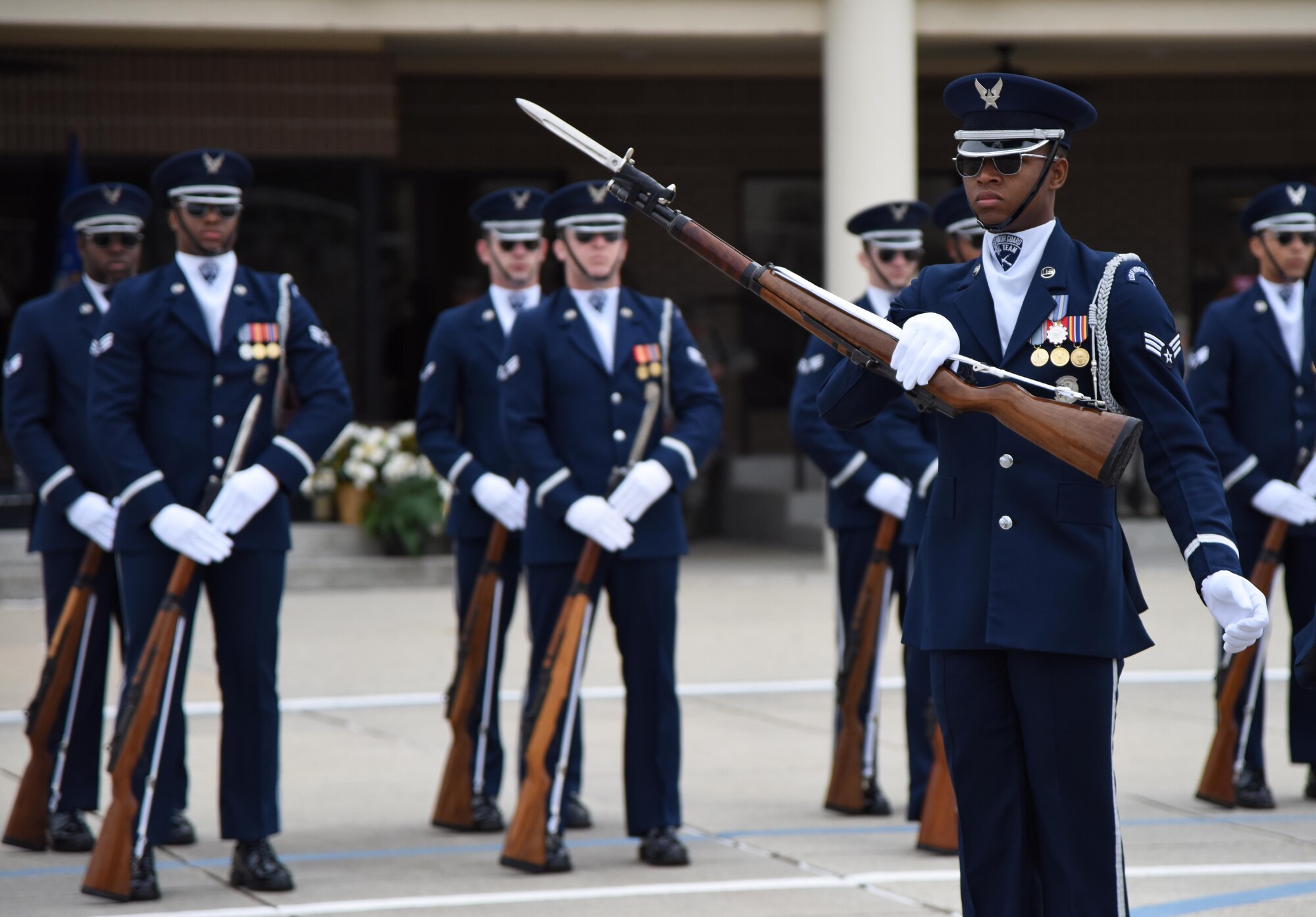 The U.S. Air Force Honor Guard Drill Team debuts their 2019 routine in front of Keesler leadership and 81st Training Group Airmen on the Levitow Training Support Facility drill pad at Keesler Air Force Base, Mississippi, Feb. 8, 2019. The team comes to Keesler every year for five weeks to develop a new routine that they will use throughout the year. (U.S. Air Force photo by Kemberly Groue)