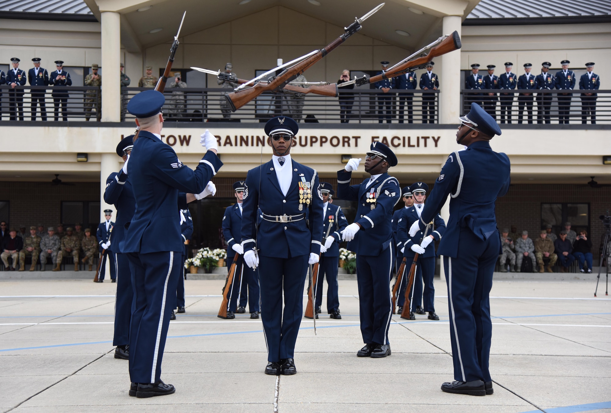 The U.S. Air Force Honor Guard Drill Team debuts their 2019 routine in front of Keesler leadership and 81st Training Group Airmen on the Levitow Training Support Facility drill pad at Keesler Air Force Base, Mississippi, Feb. 8, 2019. The team comes to Keesler every year for five weeks to develop a new routine that they will use throughout the year. (U.S. Air Force photo by Kemberly Groue)