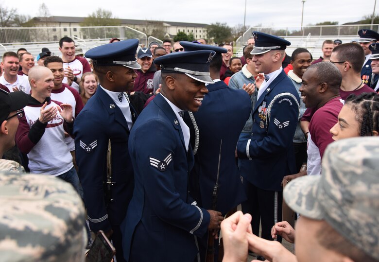 U.S. Air Force Honor Guard Drill Team members meet with Keesler leadership and 81st Training Group Airmen following the debut performance of their 2019 routine on the Levitow Training Support Facility drill pad at Keesler Air Force Base, Mississippi, Feb. 8, 2019. The team comes to Keesler every year for five weeks to develop a new routine that they will use throughout the year. (U.S. Air Force photo by Kemberly Groue)