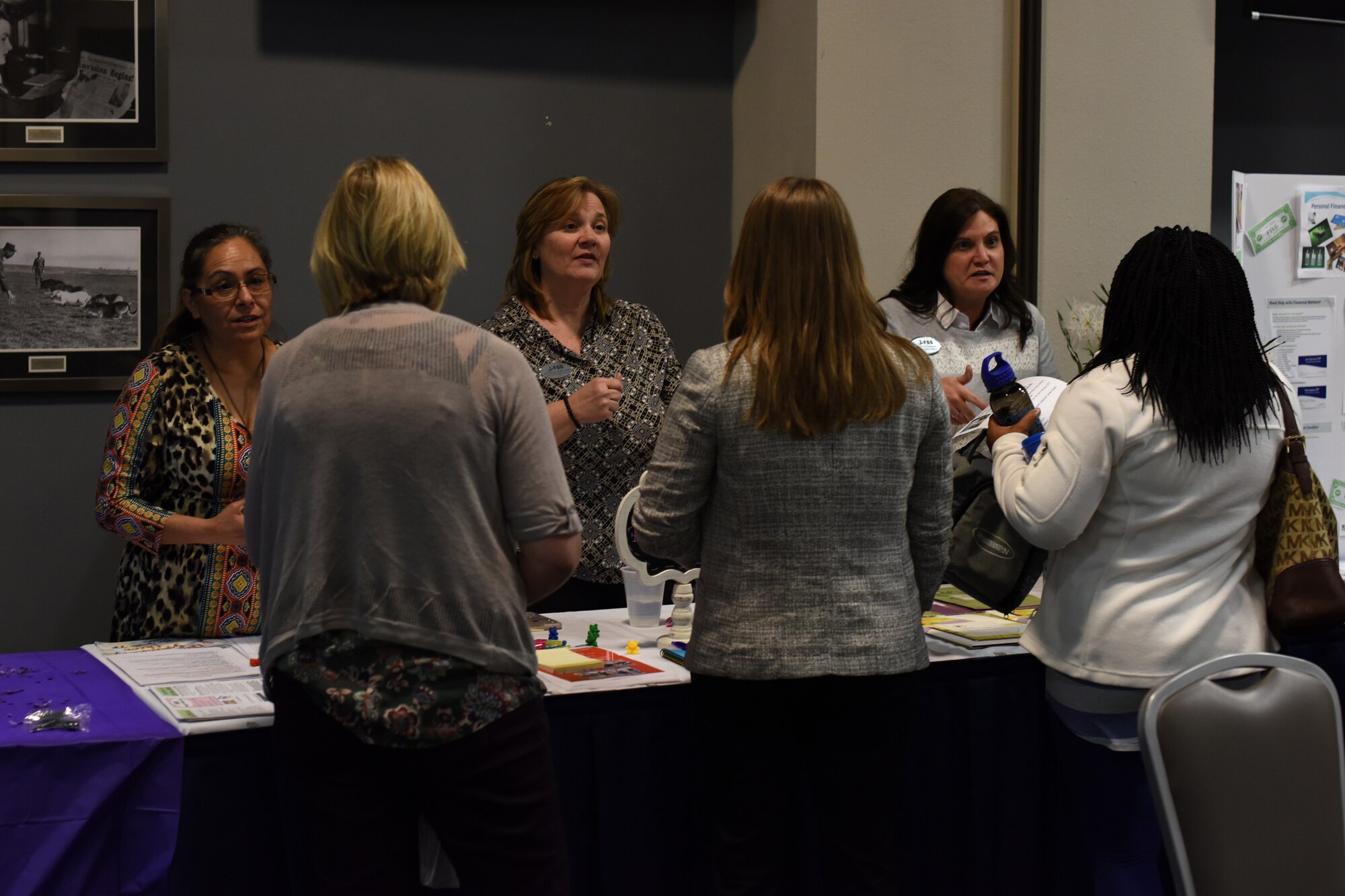 Members from 17th Force Support Squadron speak with attendees of the Key Spouses' Program All Call at the Event Center, Goodfellow Air Force Base, Texas, Feb. 7, 2019. Booths were available for anyone in attendance to ask additional questions after the question and answer portion of the night. (U.S. Air Force photo by Airman 1st Class Zachary Chapman/Released)