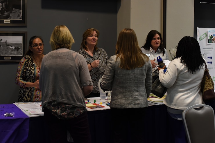 Members from 17th Force Support Squadron speak with attendees of the Key Spouses' Program All Call at the Event Center, Goodfellow Air Force Base, Texas, Feb. 7, 2019. Booths were available for anyone in attendance to ask additional questions after the question and answer portion of the night. (U.S. Air Force photo by Airman 1st Class Zachary Chapman/Released)