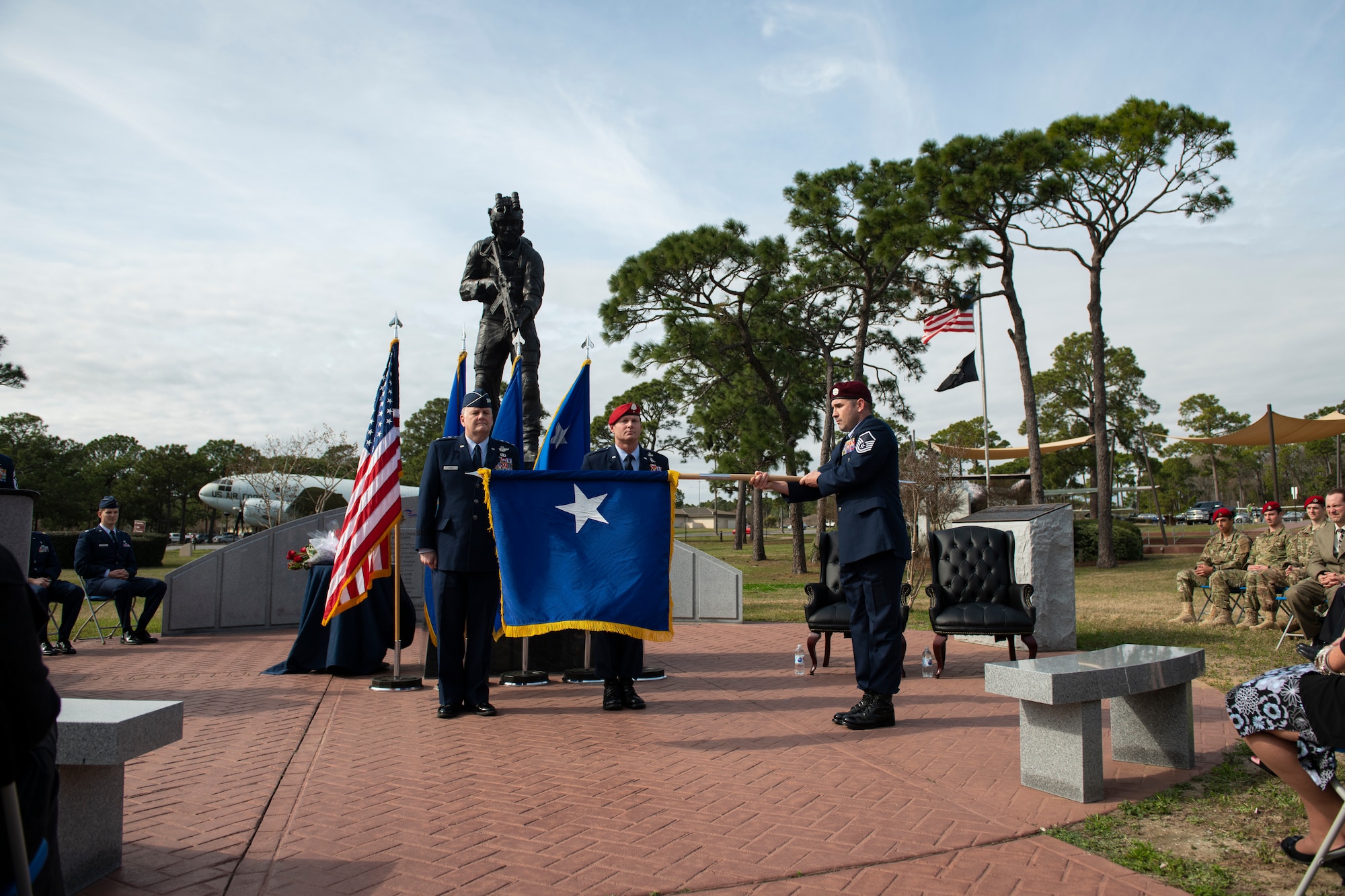 A Special Tactics pararescueman with the 24th Special Operations Wing unfurls the brigadier general flag of U.S. Air Force Brig. Gen. Claude K. Tudor, Jr., during a ceremony at Hurlburt Field, Florida, Feb. 8, 2019.