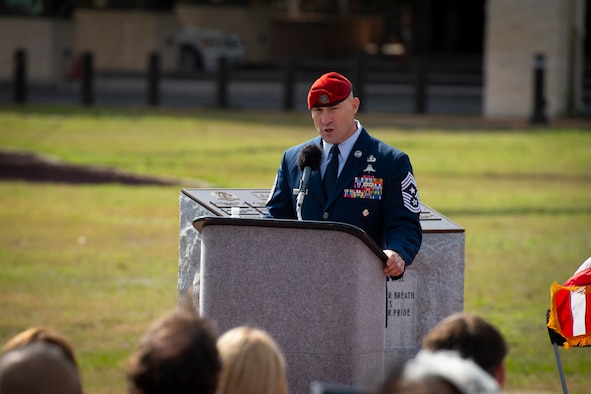 U.S. Air Force Chief Master Sgt. Jeff Guilmain, command chief of the 24th Special Operations Wing, narrates the promotion ceremony of U.S. Air Force Col. Claude K. Tudor, Jr., at Hurlburt Field, Florida, Feb. 8, 2019.
