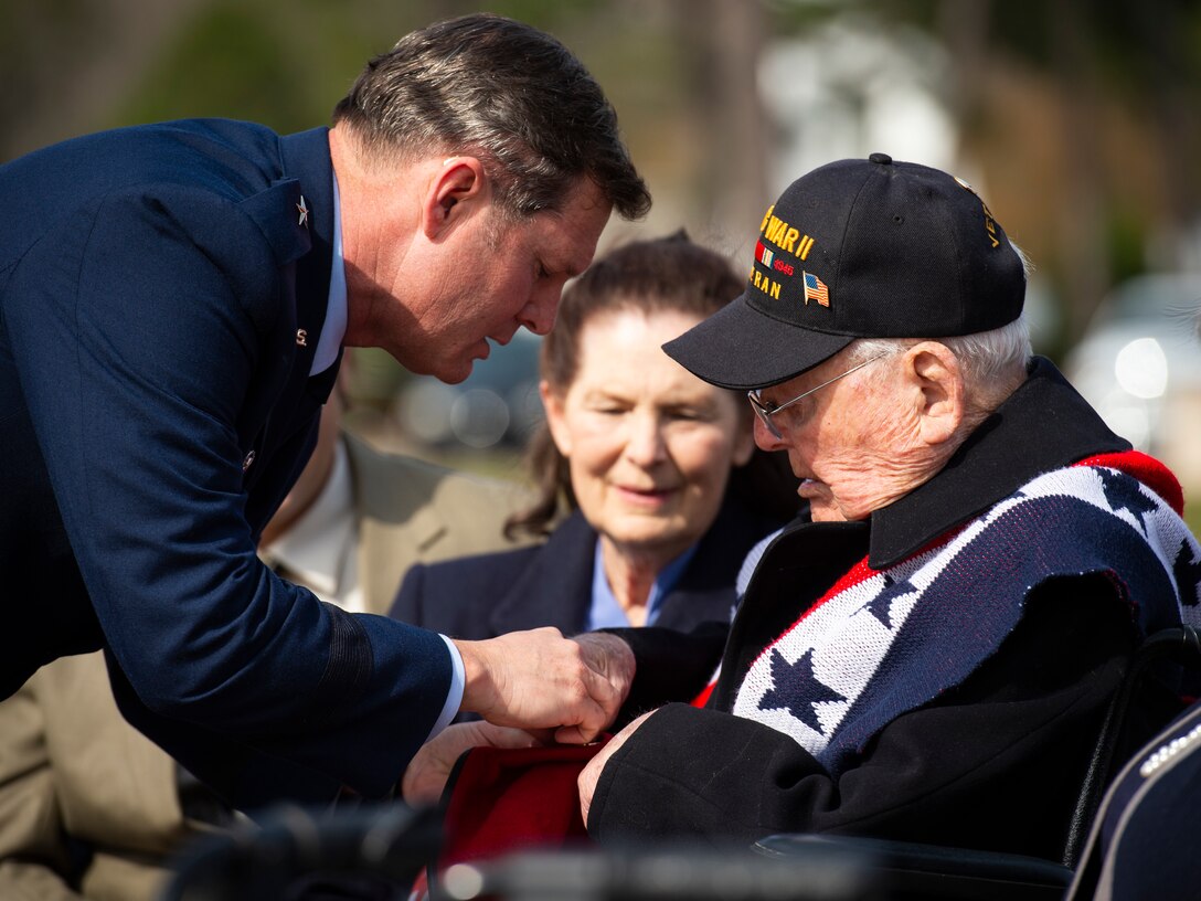 U.S. Air Force Brig. Gen. Claude K. Tudor, Jr., commander of the 24th Special Operations Wing, aids his grandfather in the pinning of the brigadier general rank on Tudor’s scarlet beret during a promotion ceremony at Hurlburt Field, Florida, Feb. 8, 2019.