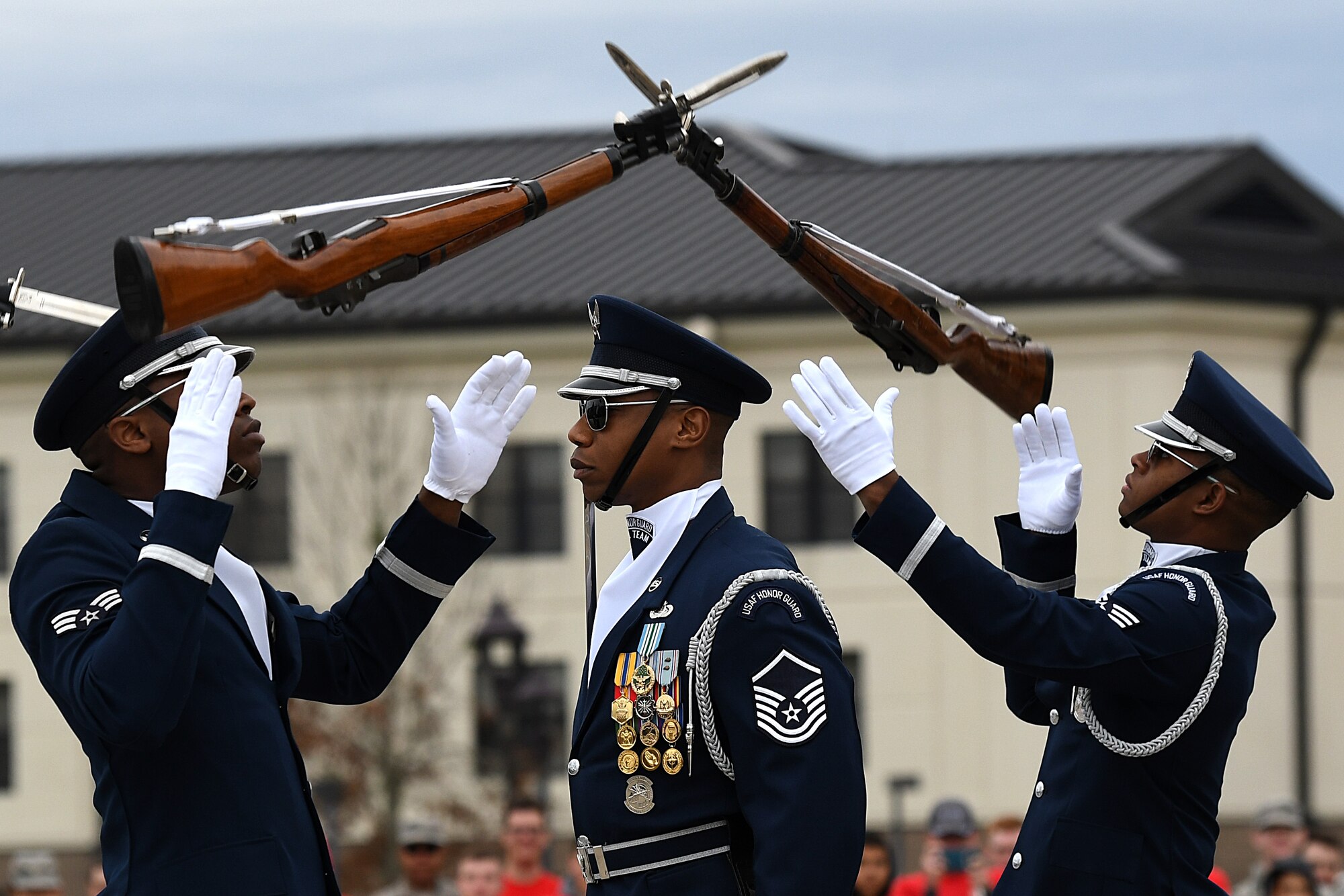 U.S. Air Force Senior Airman Bryan Satterlee, U.S. Air Force Honor Guard Drill Team member, Master Sgt. Jason Prophet, U.S. Air Force Honor Guard Drill Team superintendent, and Senior Airman Darren Lawrence, U.S. Air Force Honor Guard Drill Team member, participate in the debut of their 2019 routine in front of Keesler leadership and 81st Training Group Airmen on the Levitow Training Support Facility drill pad at Keesler Air Force Base, Mississippi, Feb. 8, 2019. The team comes to Keesler every year for five weeks to develop a new routine that they will use throughout the year. (U.S. Air Force photo by Airman 1st Class Suzie Plotnikov)