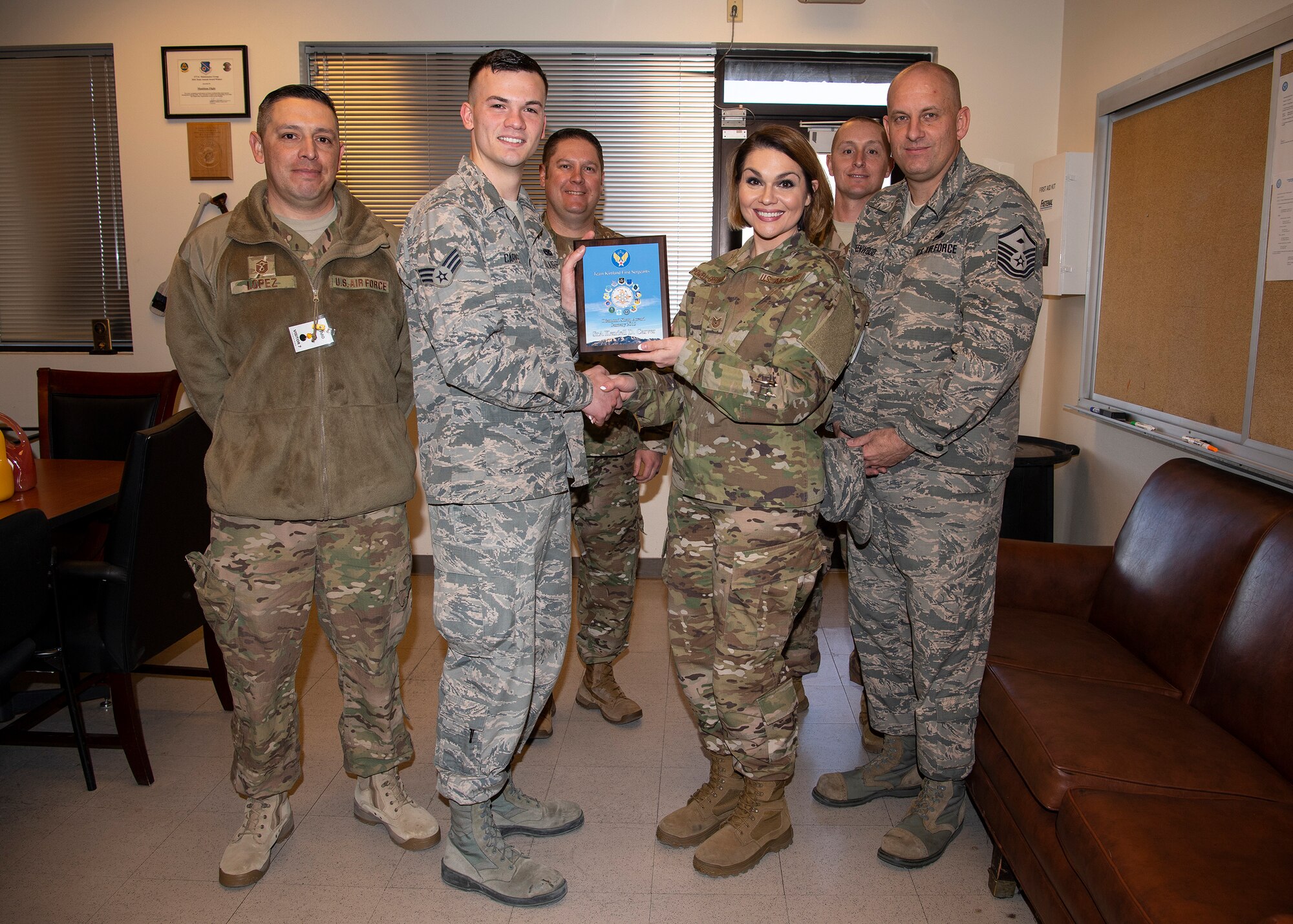 U.S. Air Force Senior Airman Kendell Carver, 377th Maintenance Squadron, receives the January Diamond Sharp award from TSgt. Robbie Powell-Greenwood, 377 MXS acting first sergeant, at Kirtland Air Force Base, N.M., Feb. 6, 2019. (U.S. Air Force photo by Staff Sgt. Kimberly Nagle)